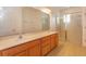 Bathroom featuring double sinks, large mirror, and walk-in shower at 147 Seville Dr, Davenport, FL 33837