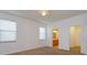 Bright bedroom with a ceiling fan, carpet, and views into the bathroom and closet at 147 Seville Dr, Davenport, FL 33837