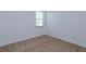 Neutral bedroom with carpet, a window with blinds, and electrical outlet at 147 Seville Dr, Davenport, FL 33837