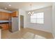 Bright breakfast nook adjacent to the kitchen with a hanging light fixture at 147 Seville Dr, Davenport, FL 33837