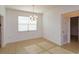 Bright, naturally lit dining area with tile flooring and hanging chandelier at 147 Seville Dr, Davenport, FL 33837
