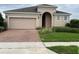 Charming single Gathering home with a two-car garage and brick paver driveway at 147 Seville Dr, Davenport, FL 33837