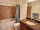 Bathroom showcasing a shower-tub combo and dark wood vanity at 150 E Robinson St # 419, Orlando, FL 32801