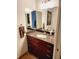 Bathroom features vanity with granite countertop, undermount sink, decorative mirror and sconce lighting at 150 E Robinson St # 419, Orlando, FL 32801