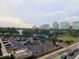 Relaxing city view from a balcony features palm trees, a park, and modern buildings at 150 E Robinson St # 419, Orlando, FL 32801