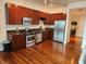 Modern kitchen with dark wood cabinets, stainless steel appliances, and hardwood floors at 150 E Robinson St # 419, Orlando, FL 32801