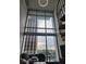 Open living area with floor-to-ceiling windows showcasing city views and spiral staircase at 150 E Robinson St # 419, Orlando, FL 32801