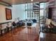 Bright living room with hardwood floors, large windows, and unique spiral staircase at 150 E Robinson St # 419, Orlando, FL 32801