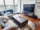 Living room boasts hardwood flooring, sliding glass doors to the balcony and modern furnishings at 150 E Robinson St # 419, Orlando, FL 32801