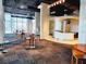 Open lounge space with modern tables, chairs and bar overlooking a city view at 150 E Robinson St # 419, Orlando, FL 32801