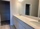 Elegant bathroom featuring a double vanity with modern fixtures and a spacious walk-in closet at 15316 Burgtheater Dr, Winter Garden, FL 34787