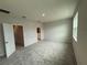 Spacious bedroom features plush carpeting, neutral walls, and ample natural light from a large window at 15316 Burgtheater Dr, Winter Garden, FL 34787