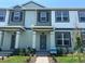 Charming townhome showcasing a welcoming facade, neat landscaping, and a well-maintained entryway at 15316 Burgtheater Dr, Winter Garden, FL 34787