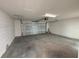 Spacious garage with a white brick perimeter and concrete floor, offering ample storage and parking at 15316 Burgtheater Dr, Winter Garden, FL 34787