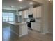 Modern kitchen featuring white cabinets, a large island with a sink, and stainless steel appliances at 15316 Burgtheater Dr, Winter Garden, FL 34787