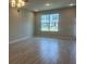Spacious living room featuring neutral walls, recessed lighting, and wood-look tile floors at 15316 Burgtheater Dr, Winter Garden, FL 34787