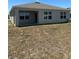 View of the house with an overgrown lawn ready for your personal touch at 1727 Buckeye Rd, Davenport, FL 33837