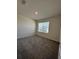 Cozy bedroom with plush carpeting and a window providing natural light at 1727 Buckeye Rd, Davenport, FL 33837