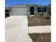 Charming single-story home with a well-maintained lawn and two-car garage at 1727 Buckeye Rd, Davenport, FL 33837
