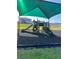 Community playground with slides, stairs, and a protective shade covering at 1727 Buckeye Rd, Davenport, FL 33837