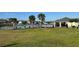 Community swimming pool with palm trees, sun loungers, and a fenced perimeter at 1727 Buckeye Rd, Davenport, FL 33837
