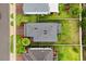 Overhead view of a home with a gray roof, green lawn, and mature palm trees at 17416 Painted Leaf Way, Clermont, FL 34714