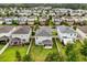 Aerial view of a well-maintained residential neighborhood, showcasing a home with a spacious backyard and patio at 17416 Painted Leaf Way, Clermont, FL 34714