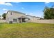 A fully fenced backyard offers privacy and space for outdoor activities with a covered patio at 17416 Painted Leaf Way, Clermont, FL 34714