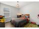 Themed bedroom featuring a cozy bed, window, and playful decor for a delight at 17416 Painted Leaf Way, Clermont, FL 34714
