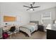 Bright bedroom with a full size bed, dark furniture, and a functional desk for daily use at 17416 Painted Leaf Way, Clermont, FL 34714