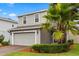Two-story home with a brick driveway, a two-car garage, and trimmed hedges at 17416 Painted Leaf Way, Clermont, FL 34714