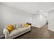 Spacious living room featuring a comfortable sofa with bright yellow accent pillows and hardwood floors at 17416 Painted Leaf Way, Clermont, FL 34714