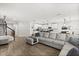 Open-concept living room and kitchen with modern finishes, stainless appliances, and lots of light at 17416 Painted Leaf Way, Clermont, FL 34714