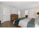 Comfortable bedroom with a wooden dresser, soft lighting, and neutral tones, creating a relaxing atmosphere at 17416 Painted Leaf Way, Clermont, FL 34714