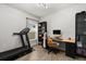 Well-lit office featuring a desk, a bookshelf, and workout equipment for a balanced work and wellness space at 17416 Painted Leaf Way, Clermont, FL 34714