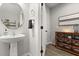 Cozy powder room featuring a pedestal sink, decor, and seamless transition into adjacent spaces at 17416 Painted Leaf Way, Clermont, FL 34714