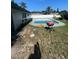 Backyard with an inground pool surrounded by grass and a white fence for privacy at 1812 Firwood Ct, Orlando, FL 32818