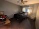 The bedroom features a comfortable bed, ceiling fan, and natural light from the window at 1812 Firwood Ct, Orlando, FL 32818
