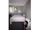 Bedroom with gray walls, a bed with striped pillows and a white blanket at 1812 Firwood Ct, Orlando, FL 32818