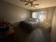The bedroom features a comfortable bed, ceiling fan, and natural light from the window at 1812 Firwood Ct, Orlando, FL 32818