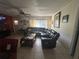 Spacious living room with tiled floors, ample natural light, and ceiling fan at 1812 Firwood Ct, Orlando, FL 32818