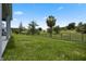 Expansive backyard with lush greenery and a black metal fence at 2168 Aibonito Cir, Clermont, FL 34711