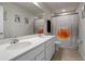 Bathroom with double vanity sinks, a large mirror and a shower with a fun decorative curtain at 2168 Aibonito Cir, Clermont, FL 34711