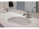 Bright bathroom featuring double sinks with chrome faucets and a large mirror at 2168 Aibonito Cir, Clermont, FL 34711