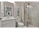 Bright bathroom featuring a glass-enclosed shower with a built-in seat, a vanity, and tile flooring at 2168 Aibonito Cir, Clermont, FL 34711