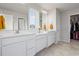 Bathroom with double vanity sinks and access to a closet at 2168 Aibonito Cir, Clermont, FL 34711