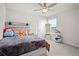 Bedroom showcasing a neutral color palette, a cozy bed, and modern ceiling fan at 2168 Aibonito Cir, Clermont, FL 34711