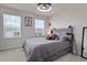 Bedroom with natural light, a cozy bed with storage and a stylish gray headboard with unique bedside lamps at 2168 Aibonito Cir, Clermont, FL 34711