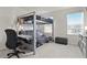Bedroom featuring a bunk bed with a desk and a bright window at 2168 Aibonito Cir, Clermont, FL 34711