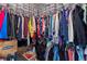 Walk-in closet showcasing organized storage with shelves, hanging rods, and clear bins for maximum space utilization at 2168 Aibonito Cir, Clermont, FL 34711